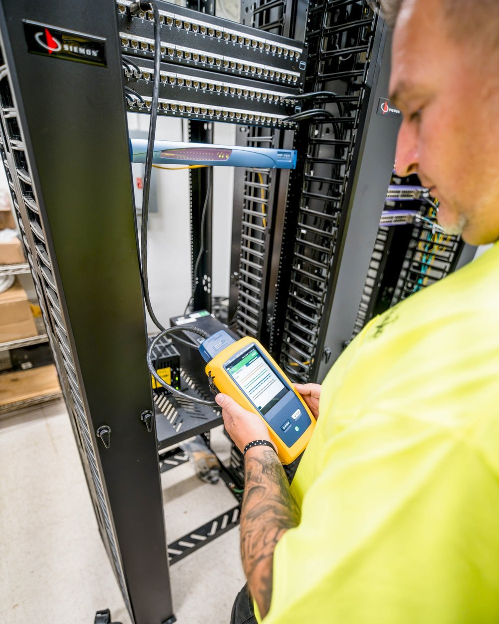 Demarc technician certifying Cat6A copper with a Fluke Versiv certifier